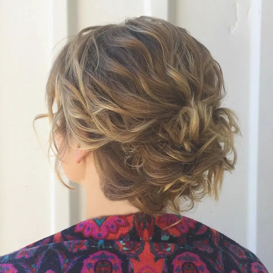 A side-swept chignon with curl